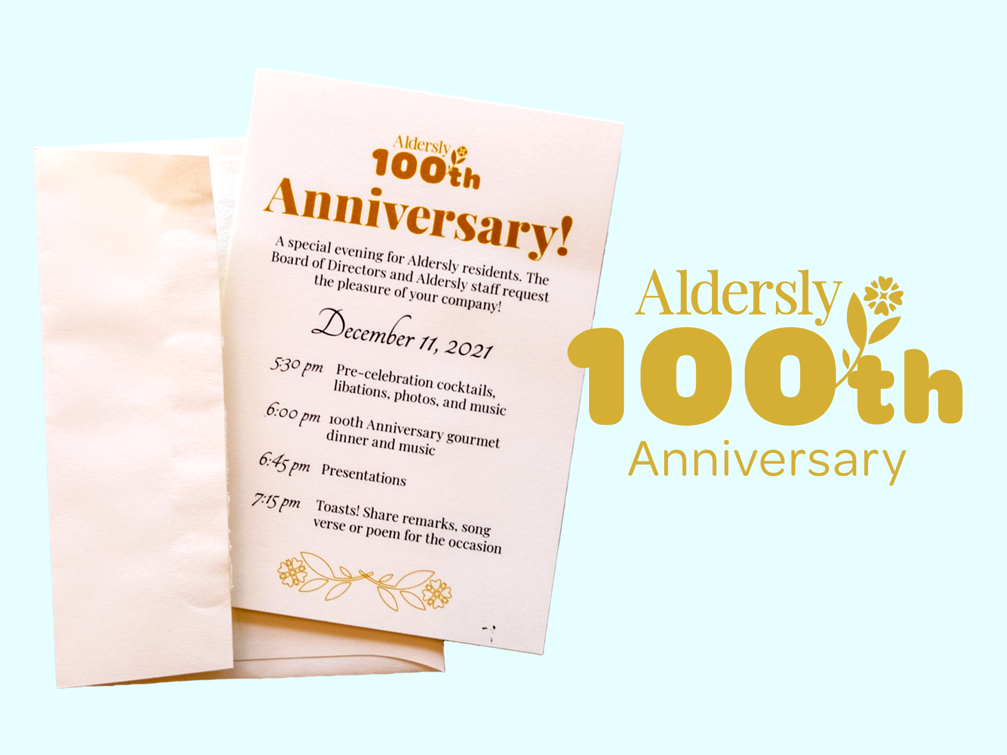 A paper envelope and invite with the digital Aldersly 100th logo displayed next to it